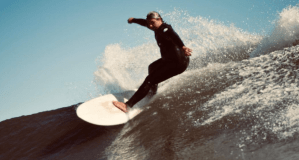 a man riding a wave on a surfboard in the water