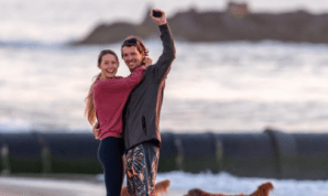 a person riding a skate board at a beach