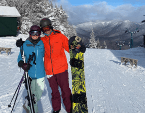 a group of people standing on top of a snow covered slope