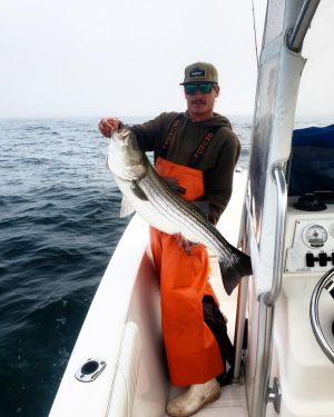 a man standing on a boat in the water