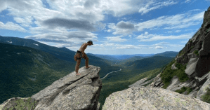 a man standing on a rocky hill