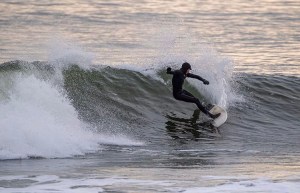 a man riding a wave on a surfboard in the ocean