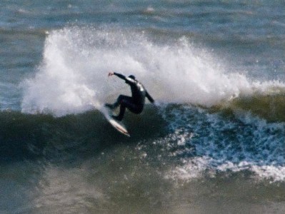 a man riding a wave on a surfboard in the water