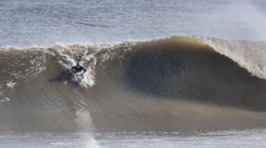 a man riding a wave on a surfboard in the water