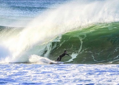 a person riding a wave on a surfboard in the water