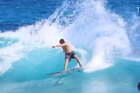 a man riding a wave on a surfboard in the water