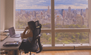 a person sitting at a table in front of a window
