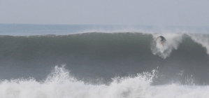 a man riding a wave on a surfboard in the water