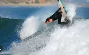 a man riding a wave on top of a body of water