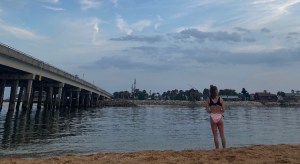 a person standing next to a body of water