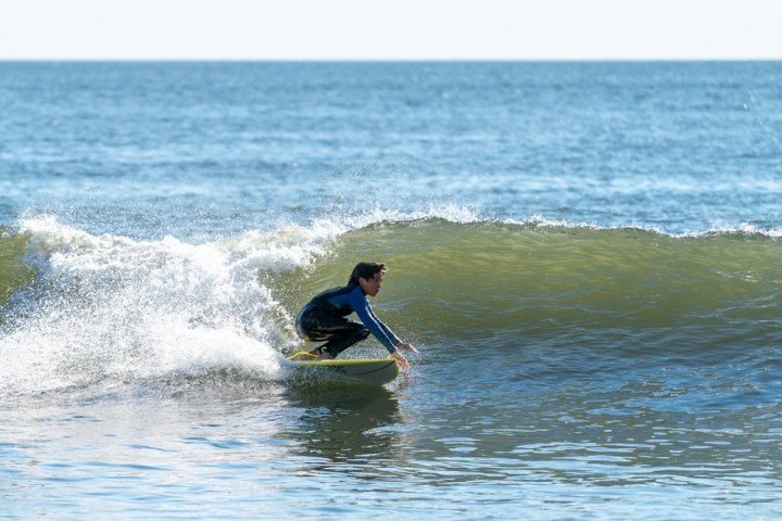 a man riding a wave on a surfboard in the ocean