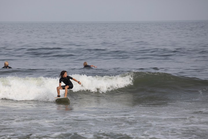 a man riding a wave on a surfboard in the ocean