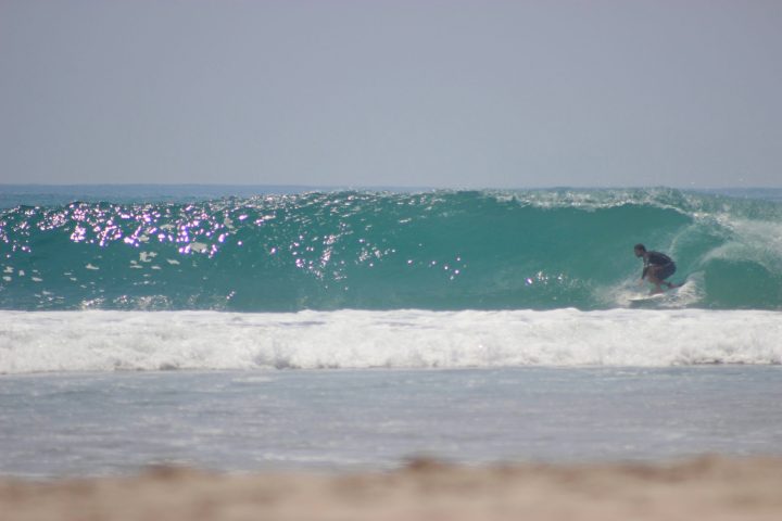 a man riding a wave on a surfboard in the ocean