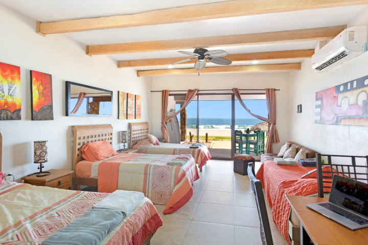 a bedroom with a bed and a chair in a room