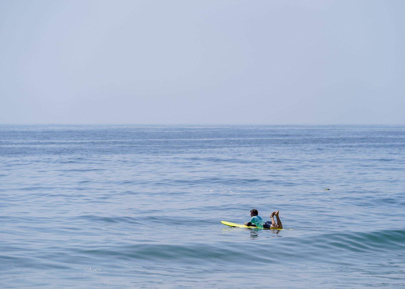 a man riding a wave on a surf board on a body of water