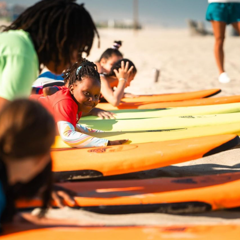 a group of people sitting at a beach