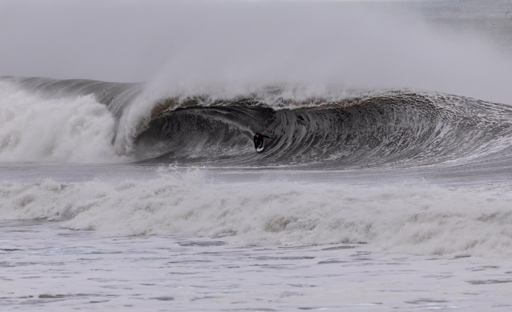 a man riding a wave on top of a body of water