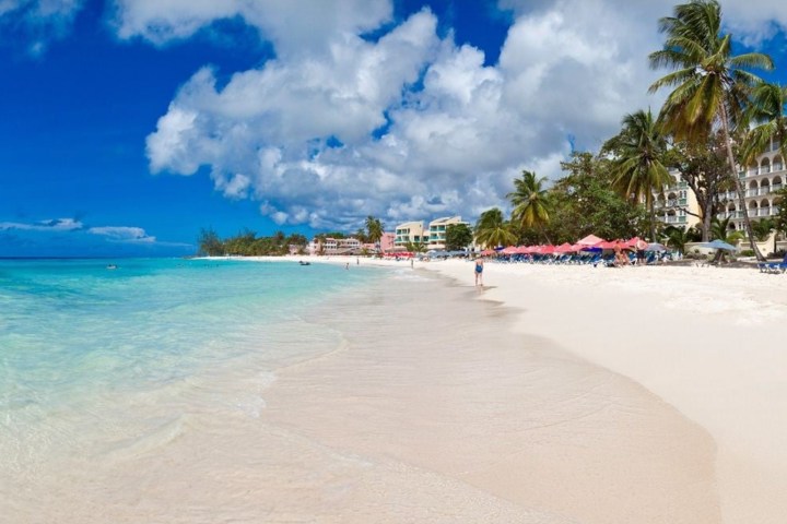 a sandy beach next to a body of water